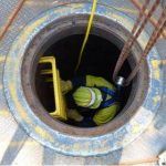 confined space entry worker on ladder cables