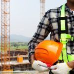 working at heights with hard hat and safety vest