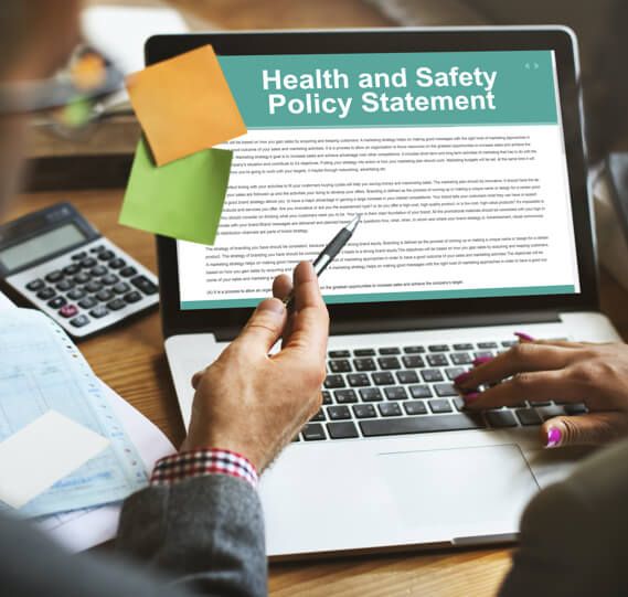 two employees review their workplace's health and safety policy statement