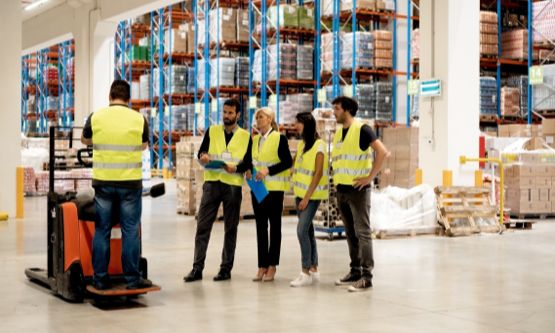 workers in yellow vests in warehouse