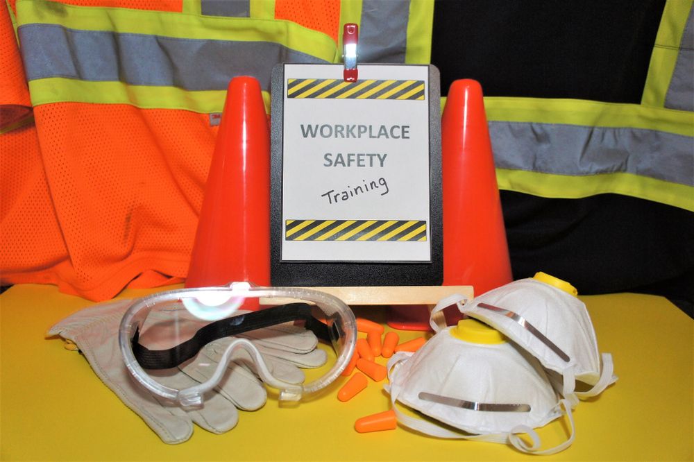 workplace safety training sign with safety equipment next to it