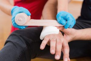 An employee providing first aid to coworker