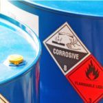Corrosive and flammable liquids in blue metal barrels