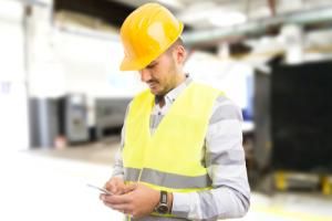 distracted factory worker on phone unsafe
