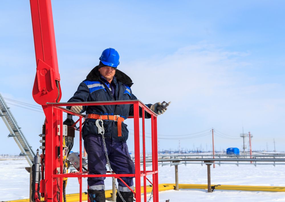 worker in safety gear in aerial lift