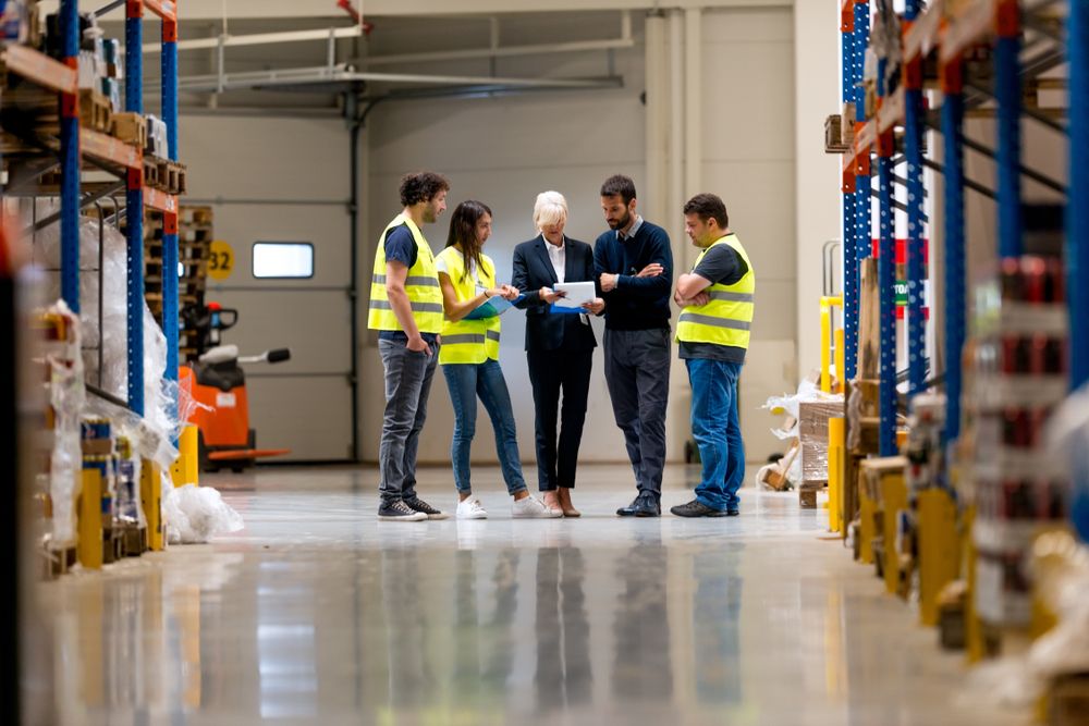A team of warehouse workers learning time management to improve workflow