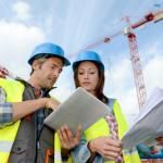 construction site with workers discussing plans