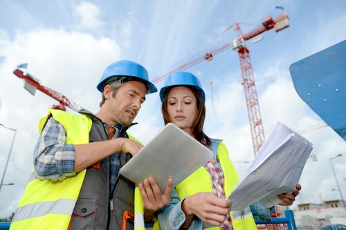 construction site with workers discussing plans