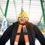 worker attached to fall arrest system for working at heights