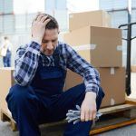stressed warehouse employee taking a break to deal with his anxiety