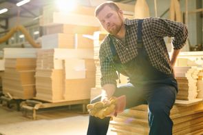 a construction worker suffers back pain from improper lifting