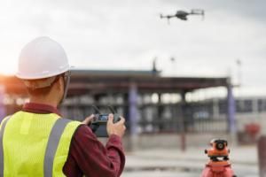 engineer uses drone at construction site