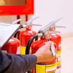 employee checking fire extinguishers