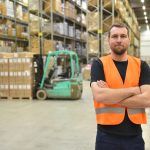 Warehouse worker posing for the camera with his arms crossed