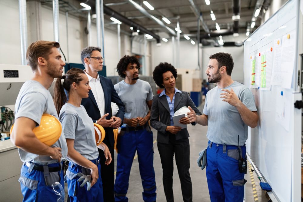 safety consultant working with a team of warehouse workers on emotional safety in the workplace