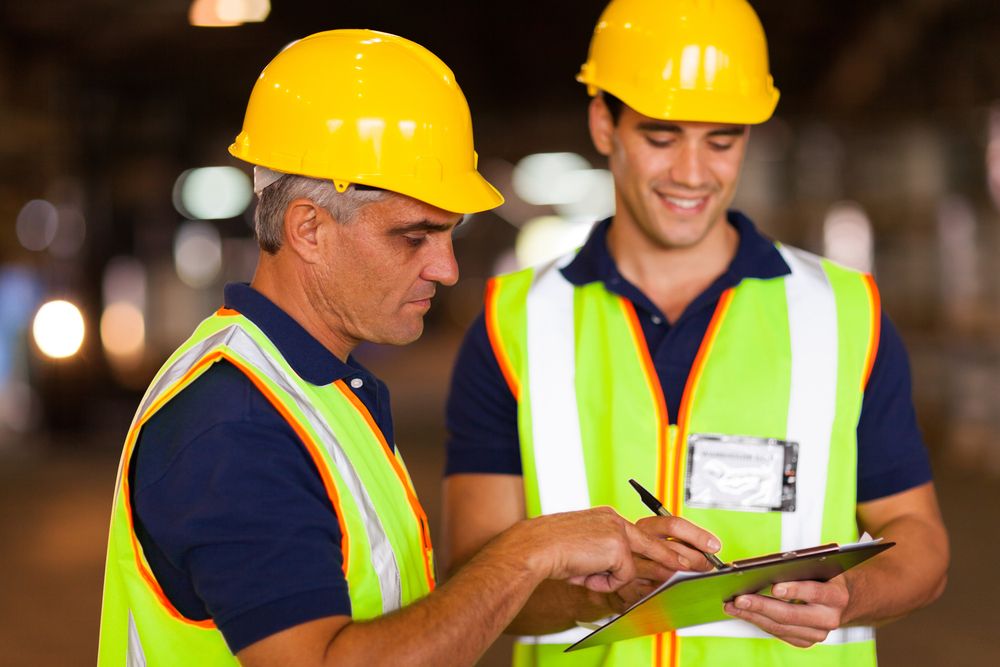 a supervisor and employee looking over the safety metrics for the month