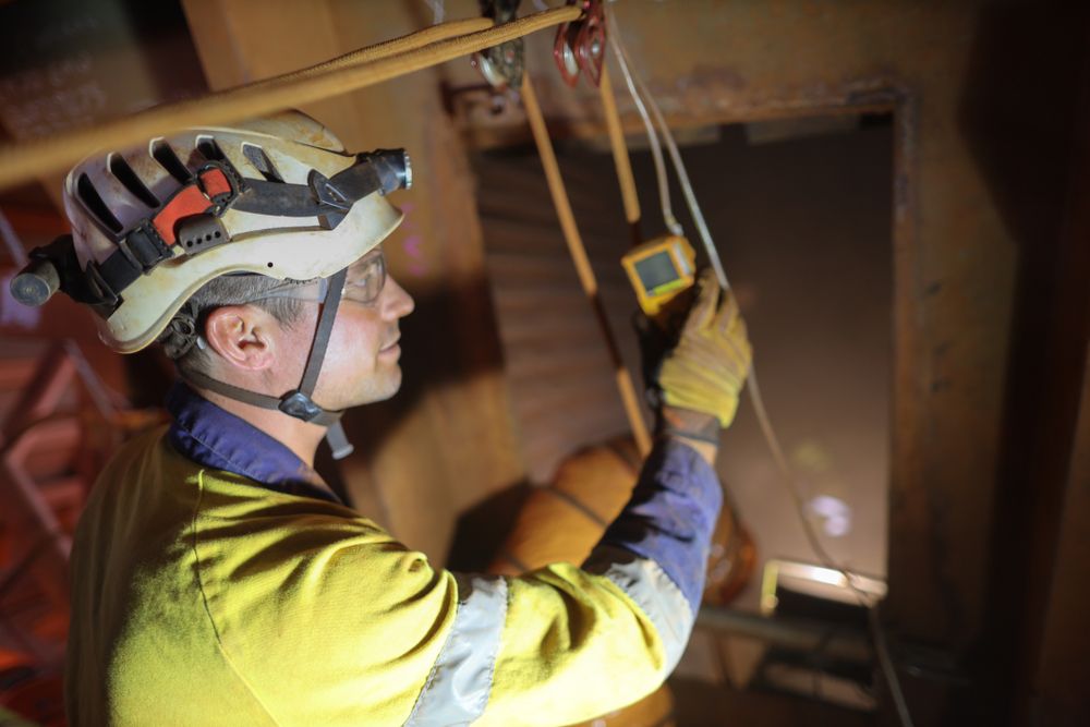 worker with protective equipment in confined space