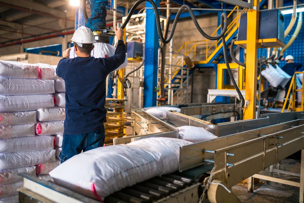 warehouse worker using the proper equipment to handle heavy items at work