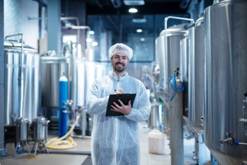 worker inspects workplace for hazards