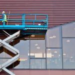 Men work at heights on scissor lift safely