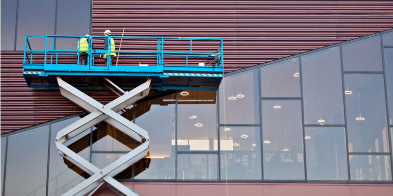 Men work at heights on scissor lift safely
