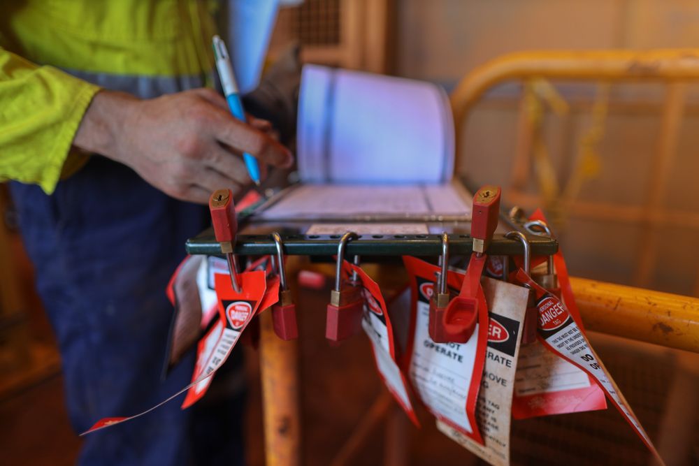 authorized worker preparing several locks for a lock out tag out procedure
