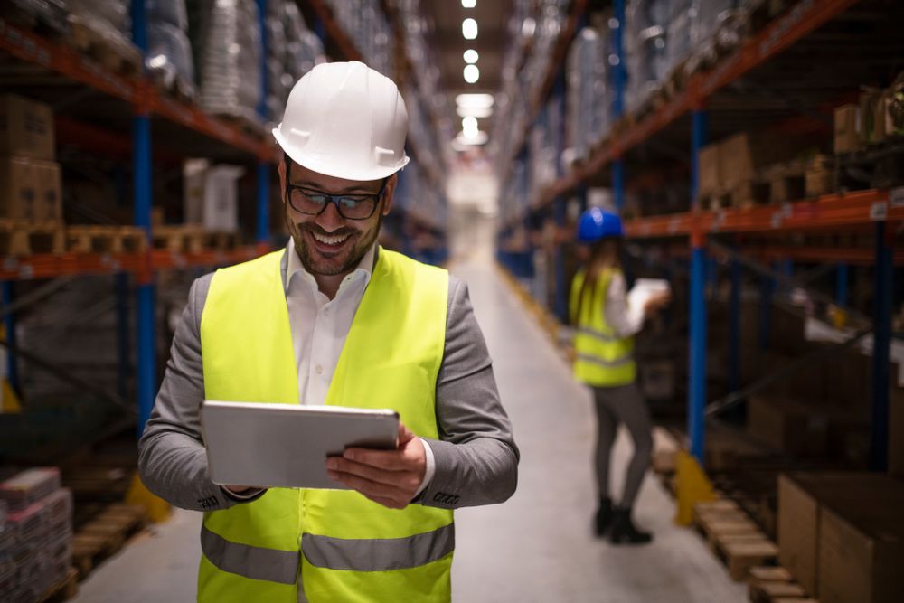 a manager walkaway from an employee smiling after talking about productivity and safety