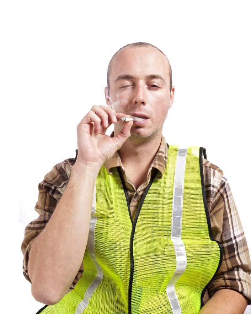 worker in safety vest smoking marijuana on the job