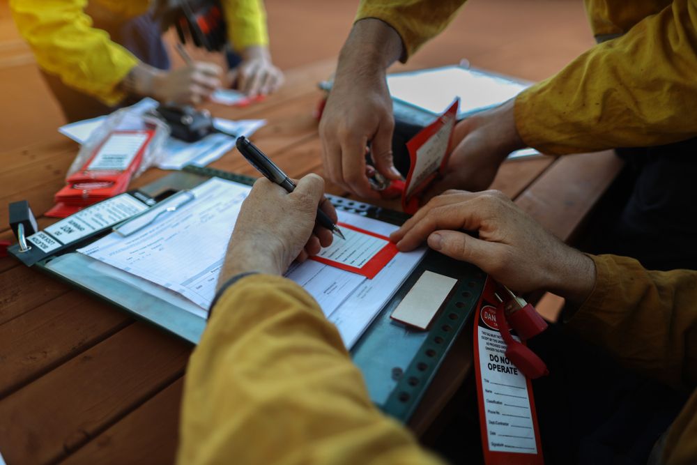 a team of workers rehearsing their safety procedures