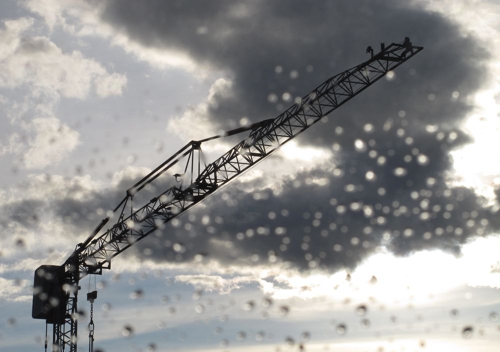 crane in the rain at an empty construction site