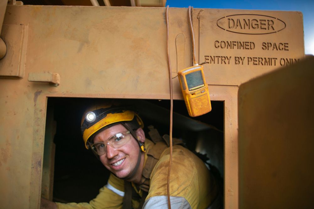 worker tests gas in confined space
