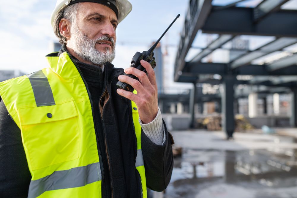a construction site supervisor making a call