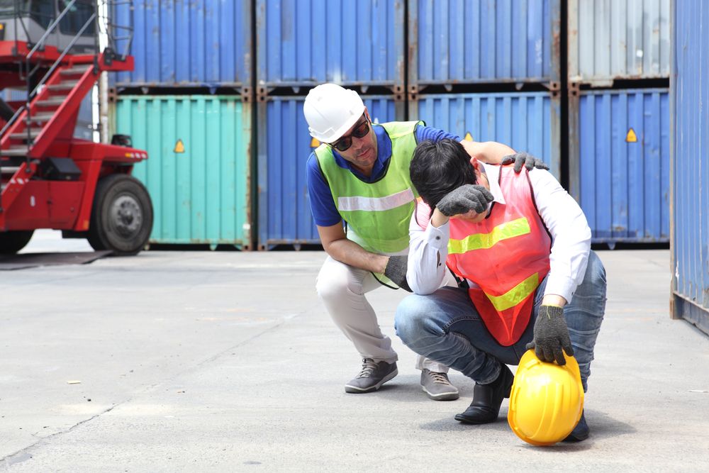 employee comforting their co-worker after a workplace accident