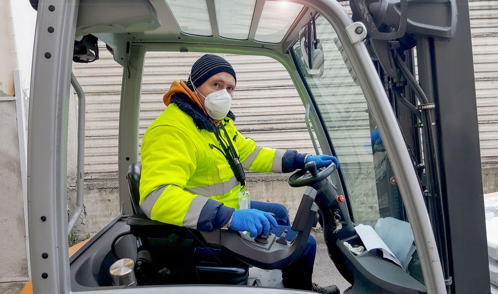 worker wears covid mask on the job
