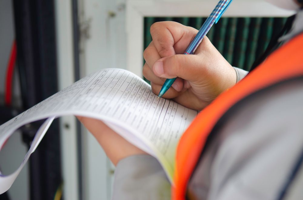 a safety consultant taking notes during a safety audit