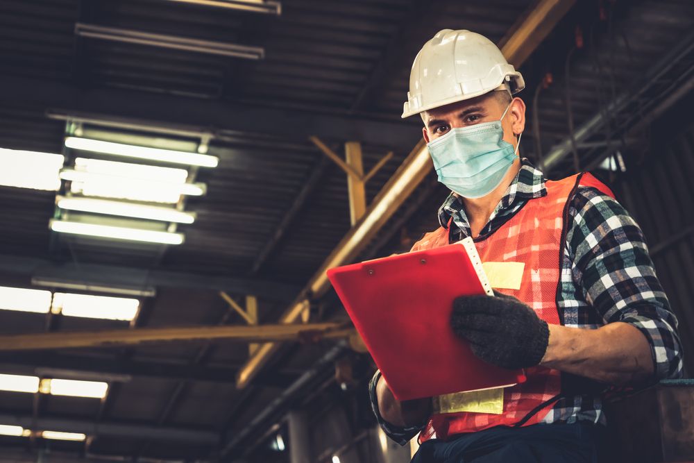 worker wears covid mask on the job