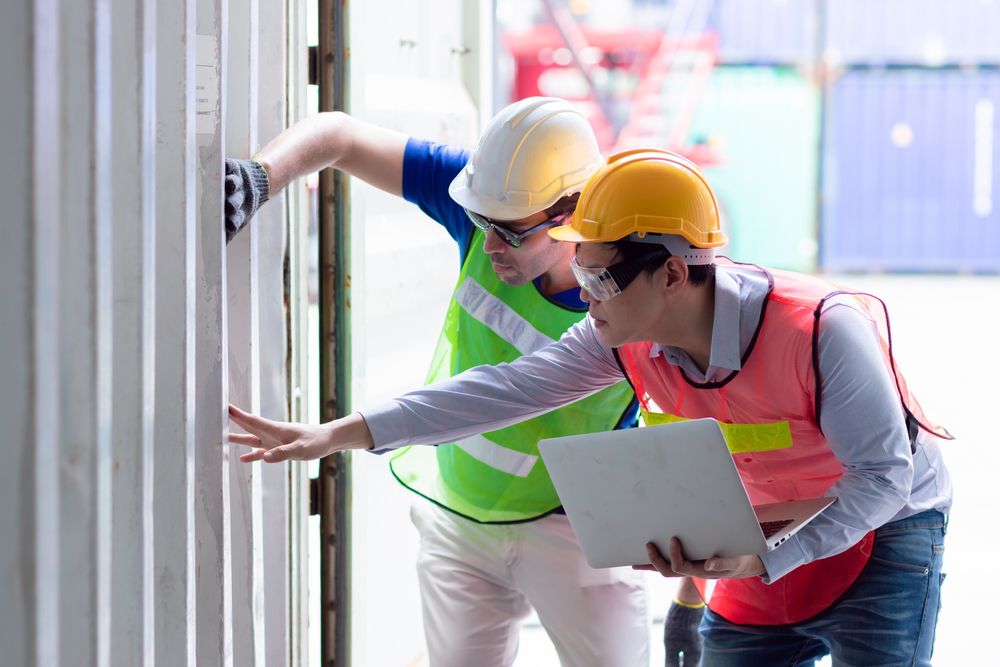 two safety consultants performing a risk assessment at a warehouse