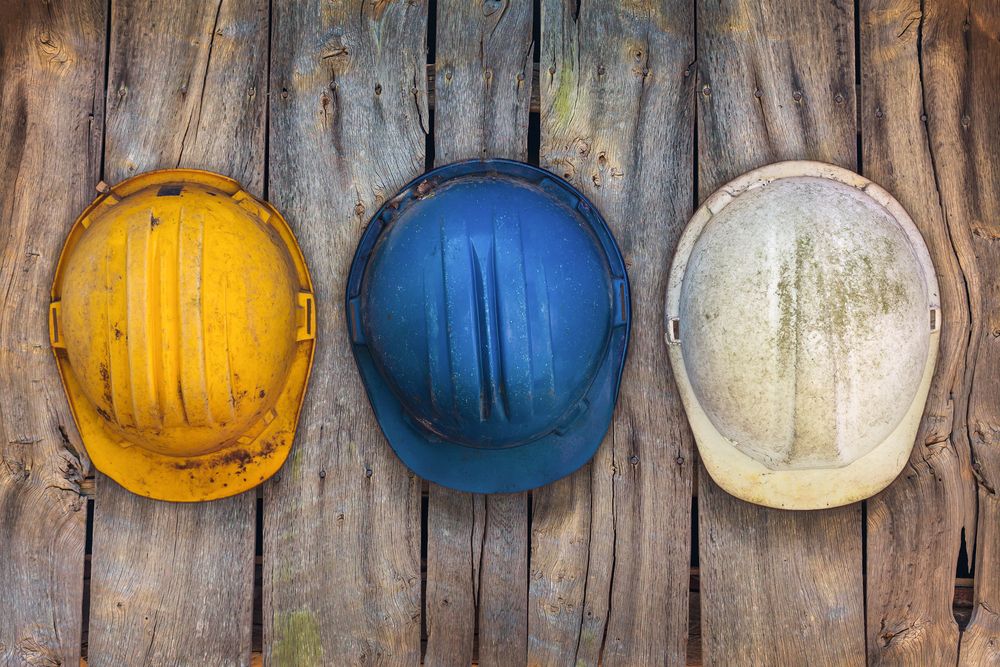 helmets hang on wall at workplace