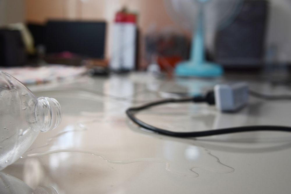 electric safety hazard - water being spilt near an electrical outlet