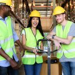 diverse group of warehouse employees laughing together