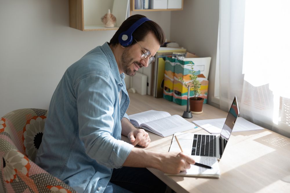 a worker taking notes during an online safety training course