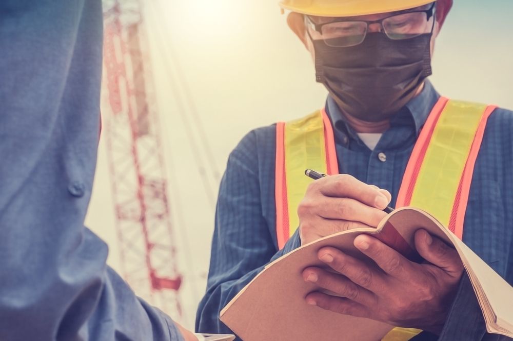 worker wears covid mask on the job