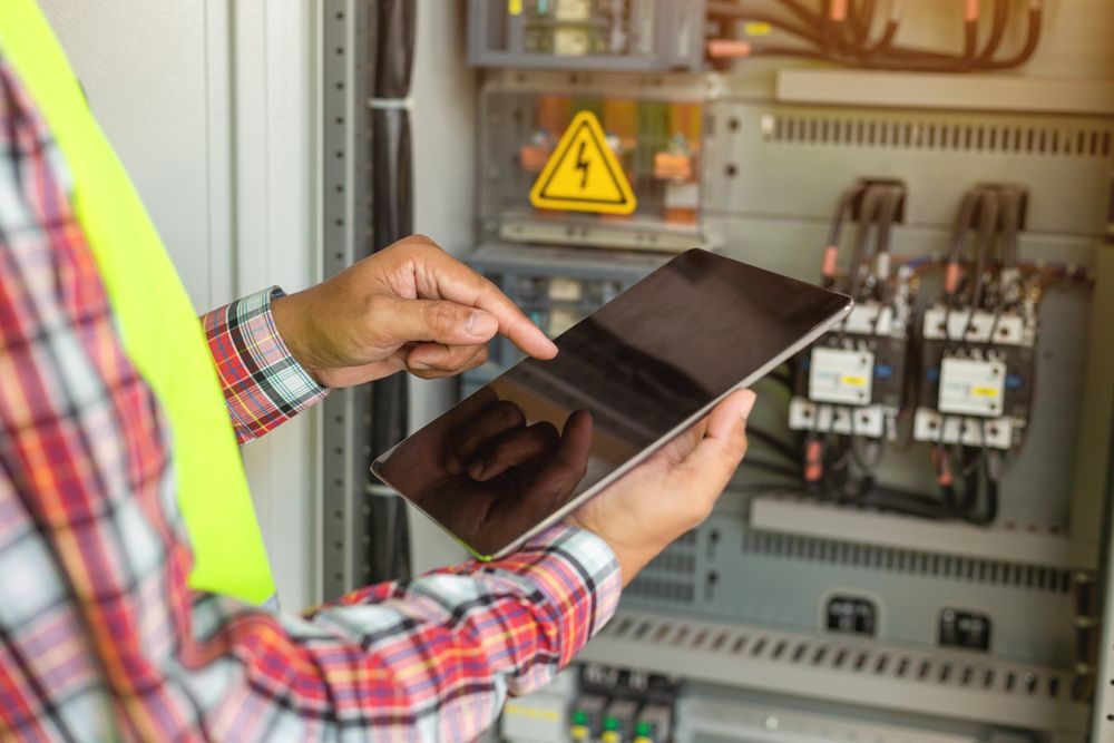 a qualified electrician sorting out an electrical issue at an office