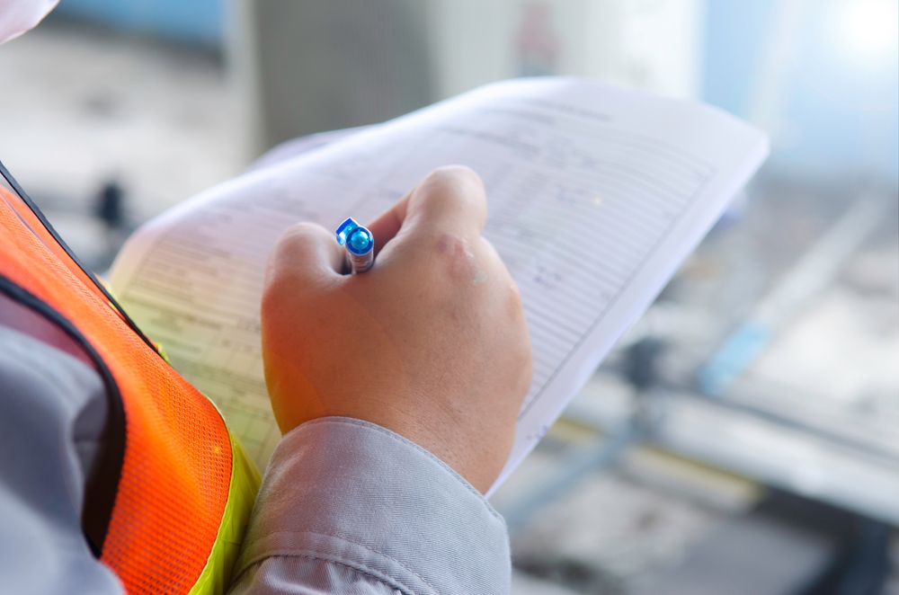 close up image of a safety inspector writing on an inspection sheet