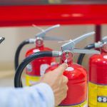 fire extinguishers being assessed for damage