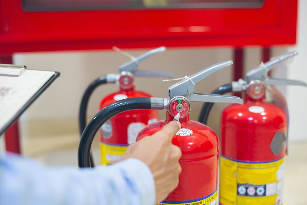 fire extinguishers being assessed for damage