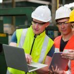 worker trains employees with laptop