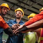 a team of safety leaders with their hands in a circle