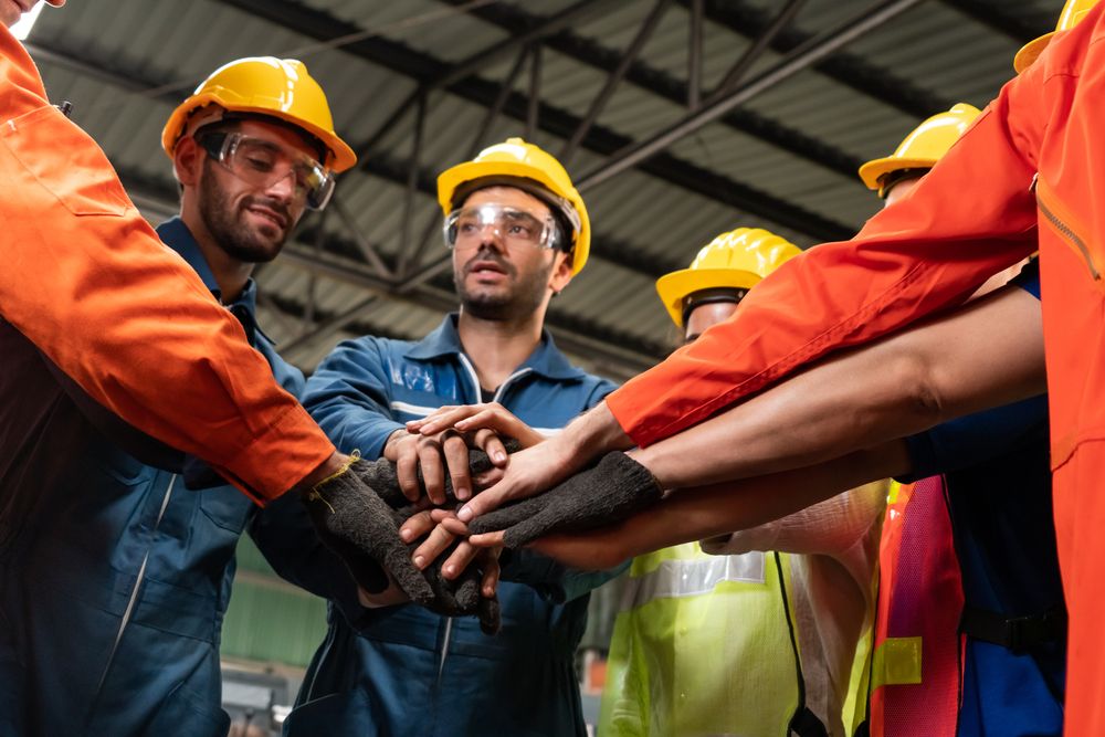 a team of safety leaders with their hands in a circle