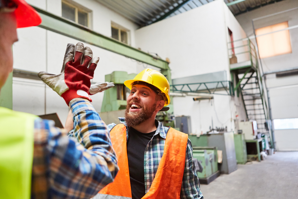 warehouse employees giving each other a high five